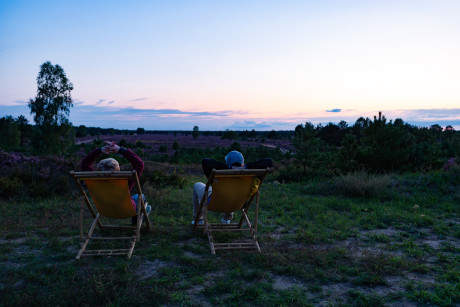 Zwei Menschen im Liegestuhl in der Kyritz-Ruppiner-Heide am Abend.